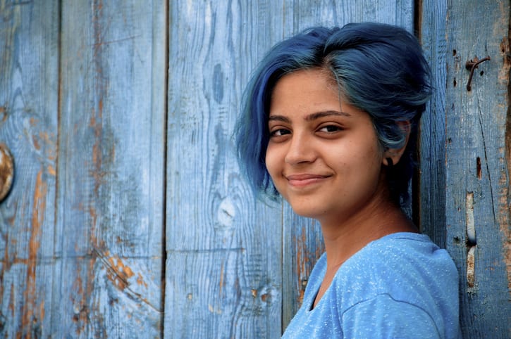 blue-haired young girl smiles blue-haired young girl smiles